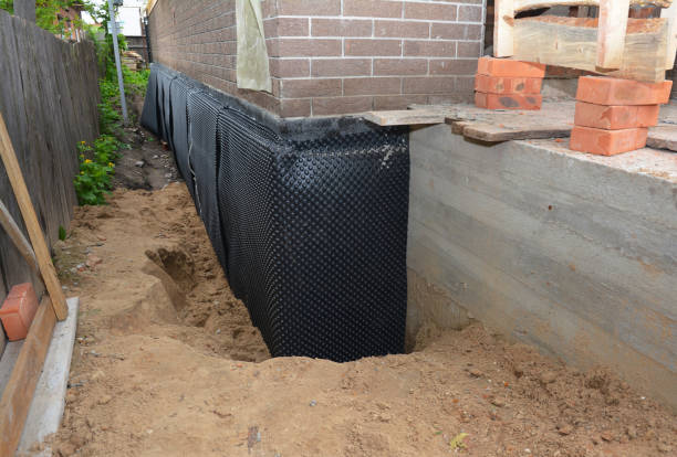Happy homeowners after waterproofing job in Mayer